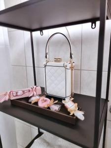 a shelf with a purse and other items on it at Fritzis Alpenidyll „Sommertraum & Winterromantik” in Samerberg