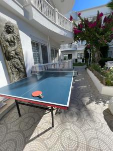 a ping pong table in front of a house at Belka Golf Residence Delux apt Poolside in Belek