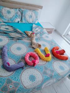 a bed with a bunch of toys on it at Belka Golf Residence Delux apt Poolside in Belek
