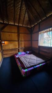 a small bedroom with a bed in a room at Kampung Bareto Cottage And Resto in Tjisurupan