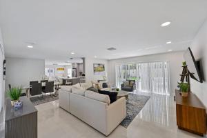 sala de estar con sofá y mesa en Sail Away Beach Cottage Sleeps 10 Heated Pool, en Fort Lauderdale