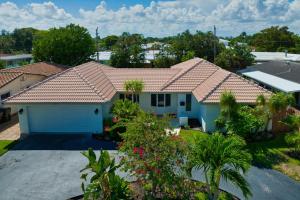 ein Haus mit einem gefliesten Dach und einem Hof in der Unterkunft Sail Away Beach Cottage Sleeps 10 Heated Pool in Fort Lauderdale