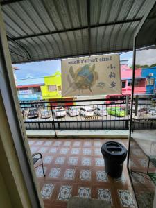 a sign on the side of a building with a balcony at LTH (Little Turtle's Home) in Semporna