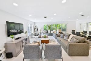 a large living room with a couch and a table at Moana Beach Cottage in Fort Lauderdale