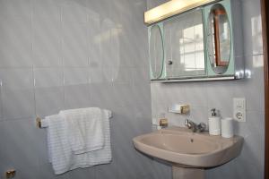 a bathroom with a sink and a mirror and towels at Apartamento Almijara in Cómpeta +22 photos
