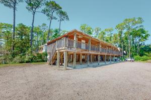 a large wooden house on top of a dirt field at Sunset Breeze #4 in Dauphin Island