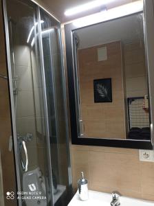 a bathroom with a sink and a mirror at Apartament Lux2 Konin NOCLEGI in Konin