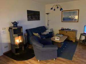 a living room with a couch and a fire place at Ferienwohnung Schwalbennest in Zudar