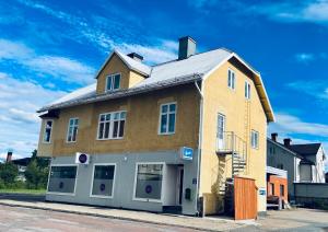 a large yellow building on the side of a street at Agardhs Pensionat in Sveg