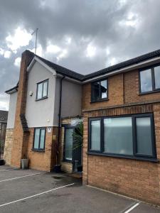 a brick building with large windows on it at No1 Guest House in Stamford