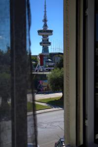 a view of a clock tower from a window at Venus in Thessaloniki