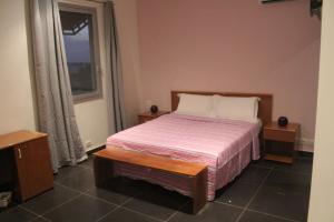 een slaapkamer met een bed en een raam bij A & A TERANGA in Somone