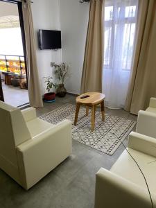 a living room with white chairs and a table at 2 Bedroom Apartment in Pereybere with Private Balcony in Pereybere