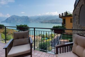 a balcony with a view of a body of water at Italian Vacation Homes - Gemini in Tavernola Bergamasca