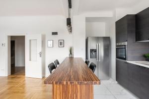 a kitchen with a wooden table and a refrigerator at CITY CENTER- stylish & sunny Appartement in Vienna