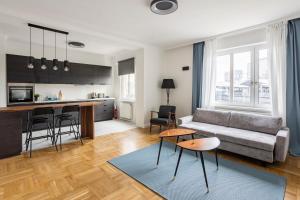 a living room with a couch and a kitchen at CITY CENTER- stylish & sunny Appartement in Vienna