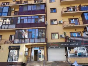 an apartment building with stairs in front of it at Fun Apartament Militari Residence in Roşu