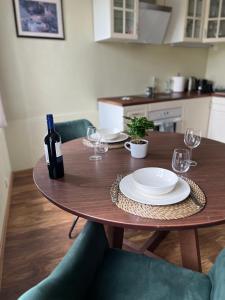 a table with a bottle of wine and glasses on it at CityView Apartment in Tallinn