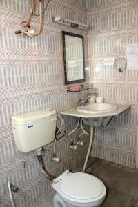 a bathroom with a toilet and a sink at Social Rehab in Bangalore