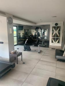 a gym with treadmills and exercise equipment in a room at Lindo Flat Particular decorado in Brasilia