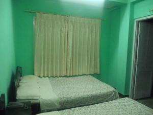 Letto o letti in una camera di Pashupati Darshan Hotel
