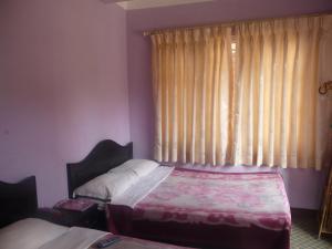 Letto o letti in una camera di Pashupati Darshan Hotel