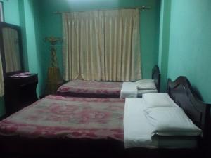 Letto o letti in una camera di Pashupati Darshan Hotel