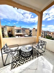 a balcony with a table and two chairs on a balcony at RaRoom Supernova H in Torre del Greco