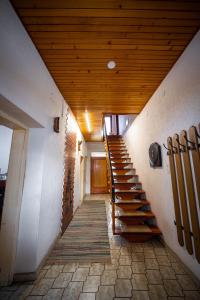 a staircase in a building with a wooden ceiling at Sonnenhaus in Gundersheim