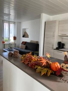 a kitchen and living room with a counter top with pumpkins at Au passe temps in Beaucourt