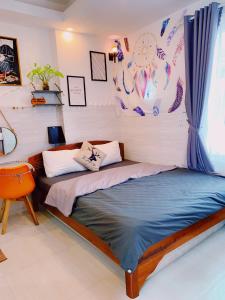 een slaapkamer met een bed en een stoel bij Lighthouse Homestay Vũng Tàu in Vung Tau
