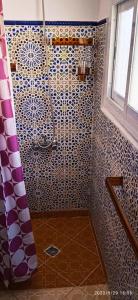 a bathroom with a shower with a shower curtain at Riad Soul of Tetouan in Tetouan