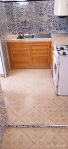 a kitchen with a sink and a stove at Riad Soul of Tetouan in Tétouan