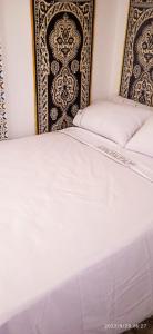 a close up of a bed in a bedroom at Riad Soul of Tetouan in Tetouan