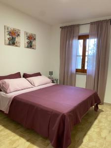 Katil atau katil-katil dalam bilik di Casa vacanze EriMar con parcheggio gratuito