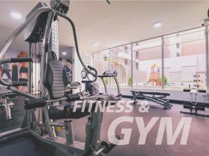 a gym with a fitness center with tread machines at Beautiful apartment Near airport /cozy Oceanfront in Lima