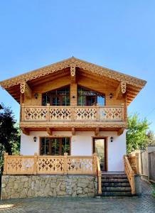 a large wooden house with a balcony at Chalet Bakuriani in Bakuriani