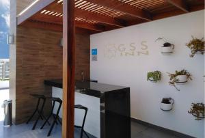 a kitchen with a counter and stools in a room at Beautiful apartment Near airport /cozy Oceanfront in Lima