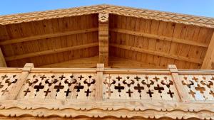 a wooden building with a wooden roof with crosses on it at Chalet Bakuriani in Bakuriani