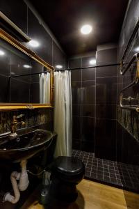 a black bathroom with a toilet and a sink at Apartments in Kaunas in Kaunas