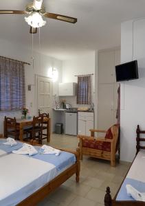 a living room with two beds and a kitchen at Villa Gelly's Studios in Aliki
