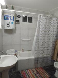 a bathroom with a bath tub and a sink at Laprida in Ramallo