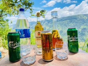 a group of bottles and glasses on a table at The Cliff Tea Glamping in Badulla