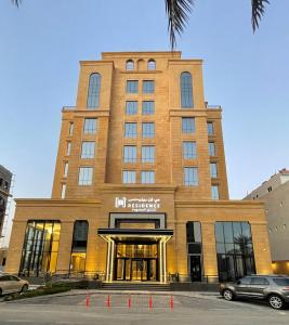 a tall building with a sign in front of it at BN Residence in Al Khobar