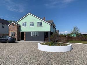 a house with a car parked in a driveway at Ranch House in Preesall