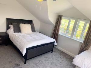 a bedroom with a bed and two windows at Ranch House in Preesall