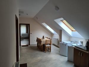 a kitchen and dining room with a table and skylights at casaafina in Harghita-Băi