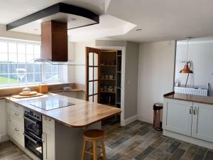 a kitchen with a wooden counter top in a room at Ranch House in Preesall