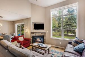 a living room with two couches and a fireplace at Aspen Getaway in Edwards