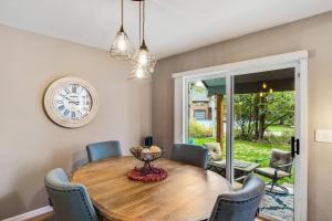 a dining room with a table and chairs and a clock at Aspen Getaway in Edwards